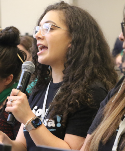 Poderosa speaking a at a community building event.